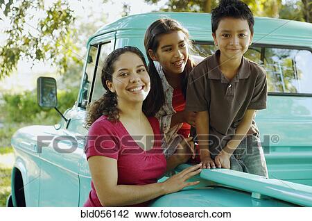 Hispanic mother and children in back of truck View Large Photo Image Stock Image - Hispanic mother and children in back of truck. Fotosearch