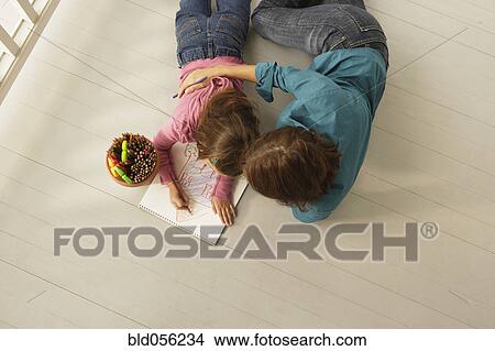 Picture - Hispanic mother and daughter coloring. Fotosearch