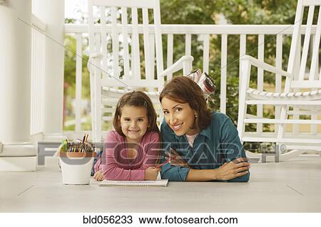 Stock Image - Hispanic mother and daughter coloring. Fotosearch