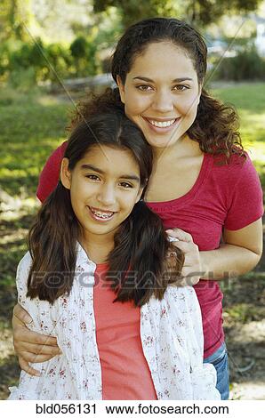 Hispanic mother and daughter hugging View Large Photo Image Stock Image - Hispanic mother and daughter hugging. Fotosearch