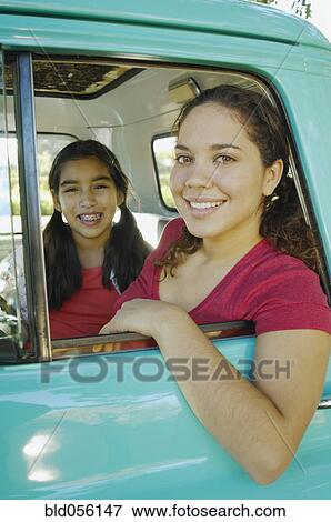 Hispanic mother and daughter sitting in truck View Large Photo Image Stock Photo - Hispanic mother and daughter sitting in truck. Fotosearch