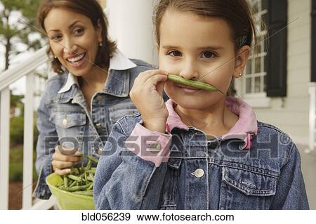 Hispanic mother and daughter with fresh green beans View Large Photo Image Stock Photo - Hispanic mother and daughter with fresh green beans. Fotosearch