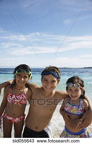Hispanic siblings hugging at beach View Large Photo Image Stock Image - Hispanic siblings hugging at beach. Fotosearch