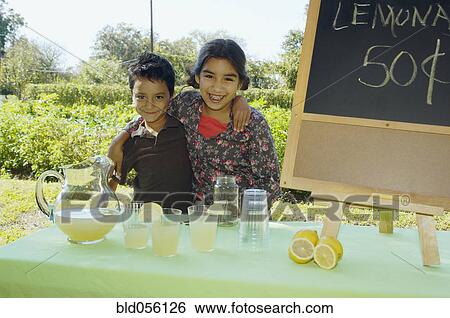 Stock Photograph - Hispanic siblings selling lemonade. Fotosearch