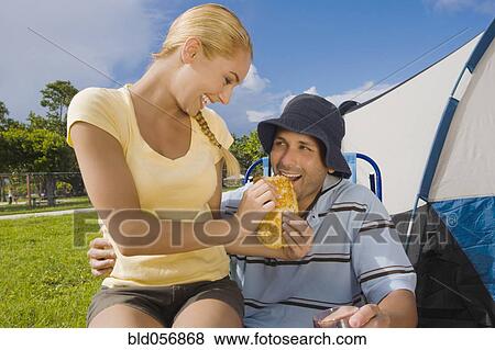 Hispanic woman feeding sandwich to boyfriend View Large Photo Image Stock Photo - Hispanic woman feeding sandwich to boyfriend. Fotosearch