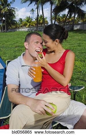 Hispanic woman feeding strawberry to boyfriend View Large Photo Image Stock Photography - Hispanic woman feeding strawberry to boyfriend. Fotosearch