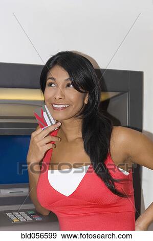 Hispanic woman holding credit card View Large Photo Image Stock Photo - Hispanic woman holding credit card. Fotosearch