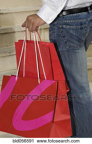 Hispanic woman holding shopping bags View Large Photo Image Stock Image - Hispanic woman holding shopping bags. Fotosearch