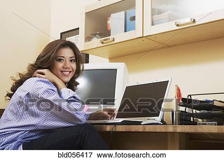 Hispanic woman in home office View Large Photo Image Stock Photo - Hispanic woman in home office. Fotosearch