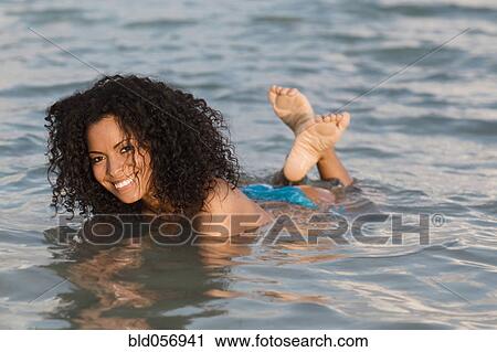 Stock Image - Hispanic woman in water. Fotosearch