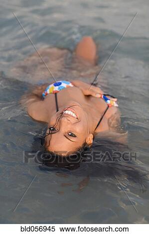 Stock Photography - Hispanic woman in water. Fotosearch