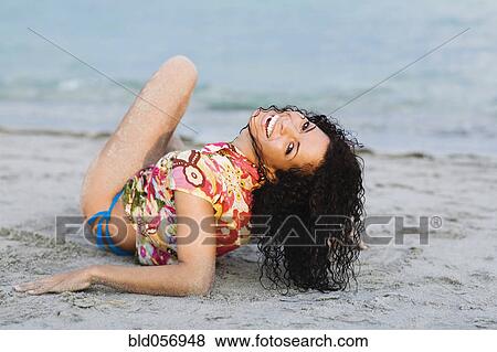 Hispanic woman laying on beach View Large Photo Image Stock Photo - Hispanic woman laying on beach. Fotosearch