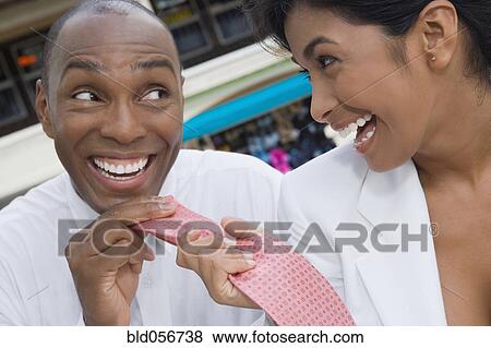 Hispanic woman pulling boyfriend’s necktie View Large Photo Image Stock Photo - Hispanic woman pulling boyfriend’s necktie. Fotosearch