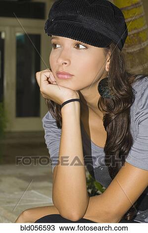 Hispanic woman resting chin on hand View Large Photo Image Stock Image - Hispanic woman resting chin on hand. Fotosearch