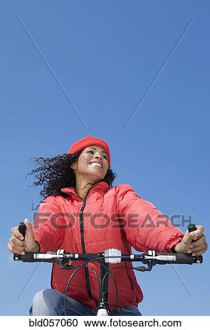 Hispanic woman riding bicycle View Large Photo Image Stock Image - Hispanic woman riding bicycle. Fotosearch