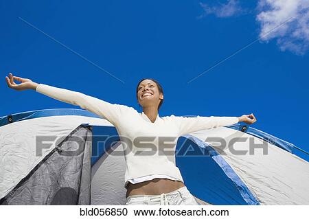Hispanic woman stretching in front of tent View Large Photo Image Stock Image - Hispanic woman stretching in front of tent. Fotosearch