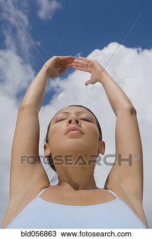 Hispanic woman stretching View Large Photo Image Stock Image - Hispanic woman stretching. Fotosearch