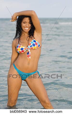 Hispanic woman wearing bikini in water View Large Photo Image Stock Image - Hispanic woman wearing bikini in water. Fotosearch