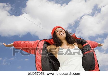 Stock Image - Hispanic woman with arms outstretched. Fotosearch