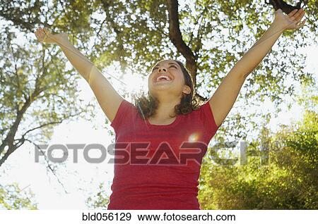 Hispanic woman with arms raised View Large Photo Image Stock Photo - Hispanic woman with arms raised. Fotosearch