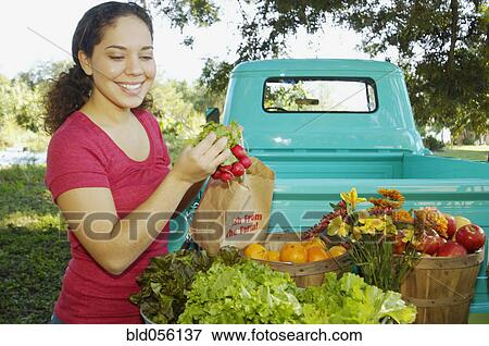 Hispanic women at organic farm stand View Large Photo Image Stock Photo - Hispanic women at organic farm stand. Fotosearch