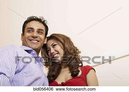 Stock Photograph - Low angle view of Multi-ethnic couple. Fotosearch
