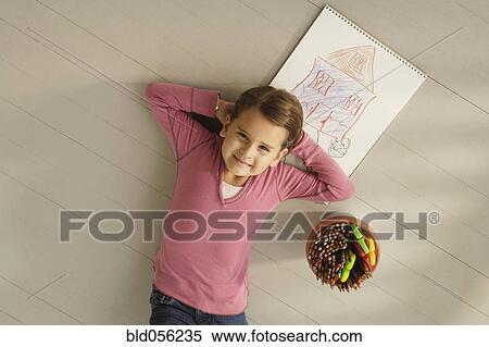 Stock Photography - Mixed Race girl next to drawing. Fotosearch