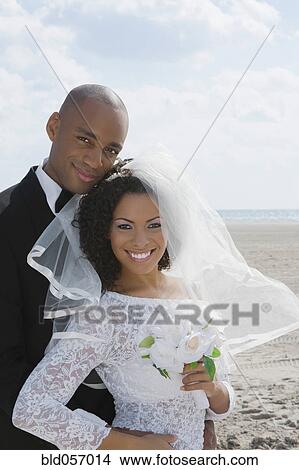 Multi-ethnic bride and groom hugging View Large Photo Image Picture - Multi-ethnic bride and groom hugging. Fotosearch