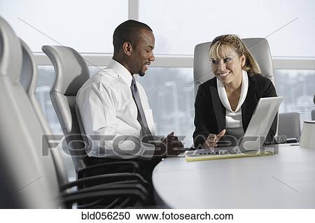Stock Image - Multi-ethnic businesspeople talking. Fotosearch