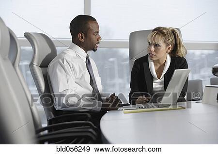 Multi-ethnic businesspeople talking View Large Photo Image Stock Photo - Multi-ethnic businesspeople talking. Fotosearch