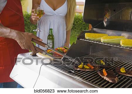 Multi-ethnic couple barbecuing View Large Photo Image Stock Image - Multi-ethnic couple barbecuing. Fotosearch