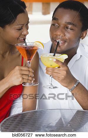 Multi-ethnic couple drinking cocktails View Large Photo Image Stock Photo - Multi-ethnic couple drinking cocktails. Fotosearch