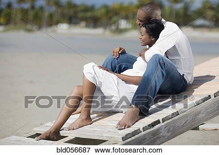 Multi-ethnic couple hugging at beach View Large Photo Image Stock Photo - Multi-ethnic couple hugging at beach. Fotosearch