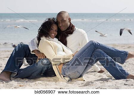 Multi-ethnic couple hugging at beach View Large Photo Image Stock Photo - Multi-ethnic couple hugging at beach. Fotosearch