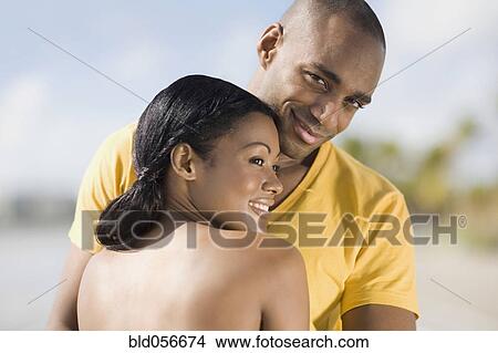 Picture - Multi-ethnic couple hugging. Fotosearch