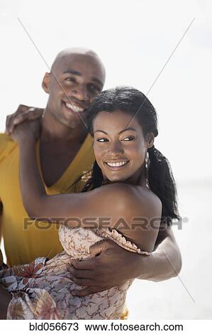 Stock Image - Multi-ethnic couple hugging. Fotosearch