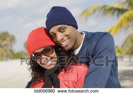 Stock Image - Multi-ethnic couple hugging. Fotosearch
