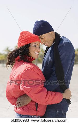 Stock Image - Multi-ethnic couple hugging. Fotosearch