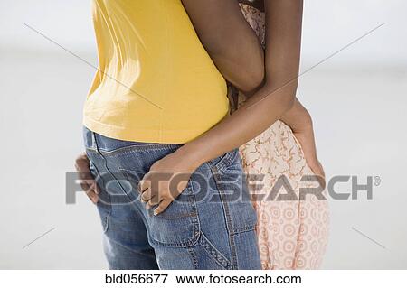 Stock Photo - Multi-ethnic couple hugging. Fotosearch