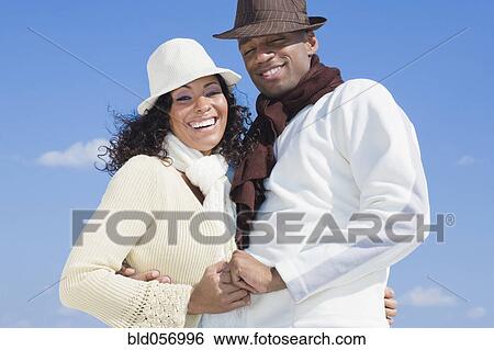 Stock Photograph - Multi-ethnic couple hugging. Fotosearch