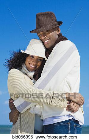Stock Photography - Multi-ethnic couple hugging. Fotosearch
