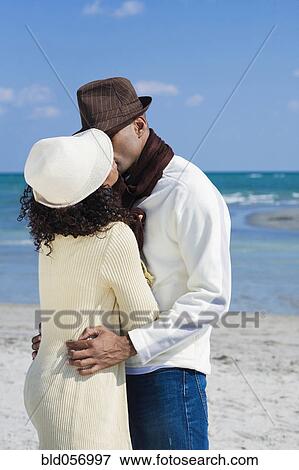 Stock Photo - Multi-ethnic couple kissing. Fotosearch