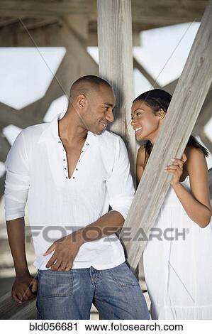 Multi-ethnic couple smiling at each other View Large Photo Image Stock Image - Multi-ethnic couple smiling at each other. Fotosearch