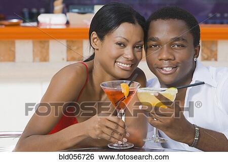 Multi-ethnic couple toasting with cocktails View Large Photo Image Stock Photograph - Multi-ethnic couple toasting with cocktails. Fotosearch