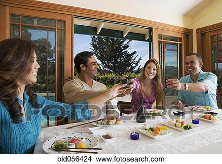 Multi-ethnic couples eating sushi View Large Photo Image Picture - Multi-ethnic couples eating sushi. Fotosearch