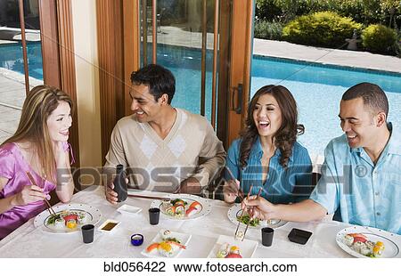 Stock Image - Multi-ethnic couples eating sushi. Fotosearch