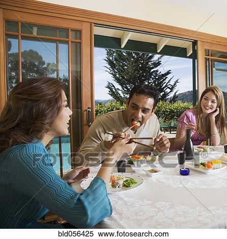 Multi-ethnic couples eating sushi View Large Photo Image Stock Photography - Multi-ethnic couples eating sushi. Fotosearch