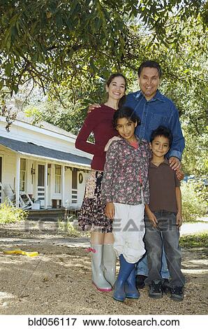 Multi-ethnic family in front of house View Large Photo Image Stock Photo - Multi-ethnic family in front of house. Fotosearch