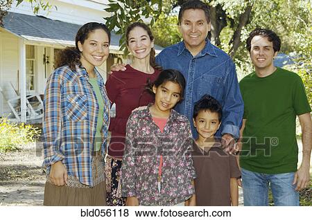 Stock Photo - Multi-ethnic family in front of house. Fotosearch