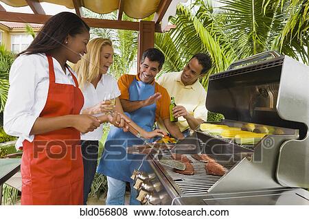Stock Photo - Multi-ethnic friends barbecuing. Fotosearch